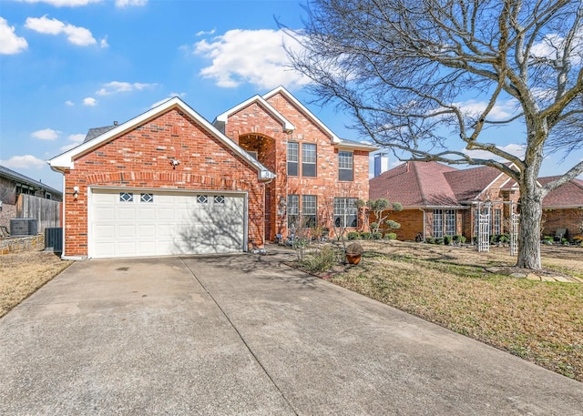 traditional home featuring an attached garage, central AC unit, concrete driveway, and brick siding