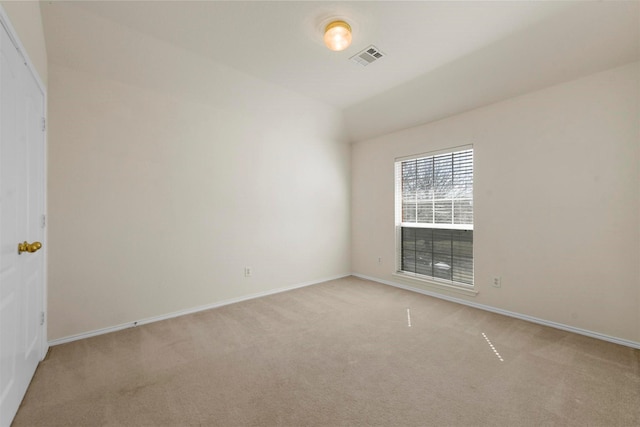 unfurnished room featuring light carpet, visible vents, and baseboards