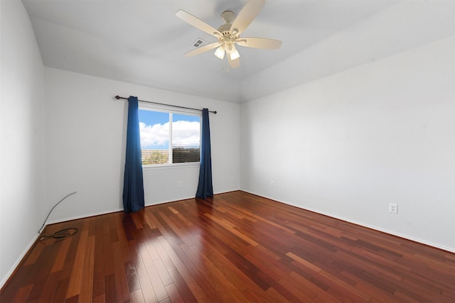 unfurnished room featuring hardwood / wood-style flooring, visible vents, and a ceiling fan