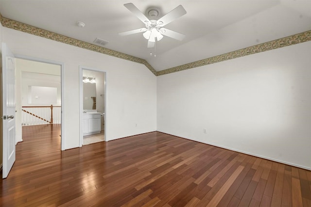 empty room featuring a ceiling fan, lofted ceiling, visible vents, and hardwood / wood-style floors