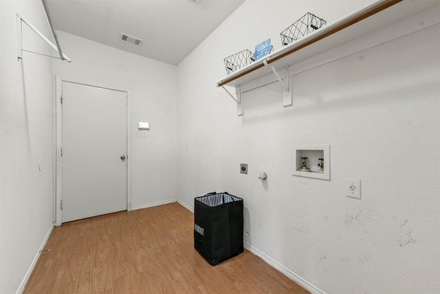 laundry room with laundry area, visible vents, hookup for a washing machine, hookup for an electric dryer, and light wood-type flooring