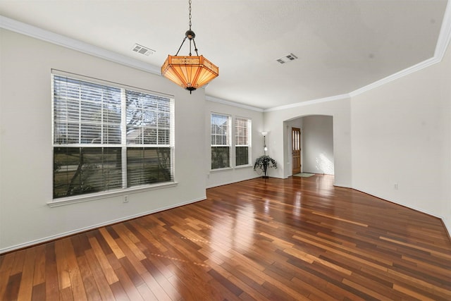 interior space with ornamental molding, arched walkways, wood-type flooring, and visible vents