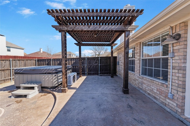 view of patio / terrace featuring a hot tub, a fenced backyard, and a pergola