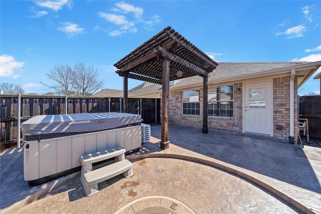 view of patio / terrace with a fenced backyard, a jacuzzi, and a pergola