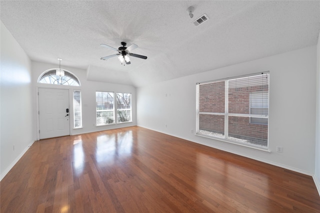 entrance foyer with lofted ceiling, visible vents, ceiling fan, and wood finished floors