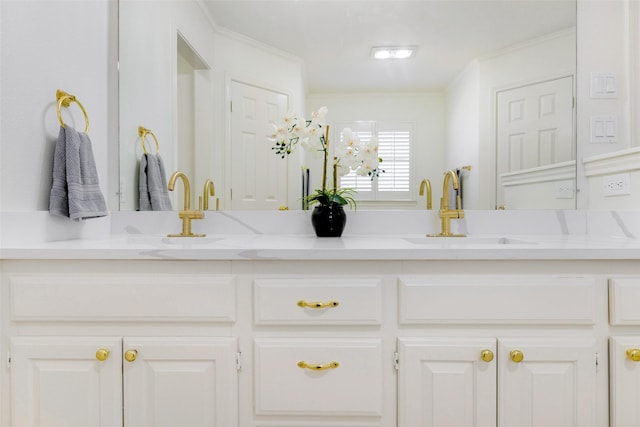 bathroom with double vanity, ornamental molding, and a sink