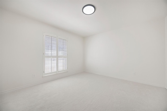 carpeted spare room with baseboards