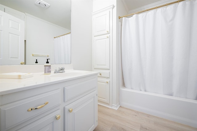 bathroom with shower / bathtub combination with curtain, wood finished floors, visible vents, vanity, and crown molding