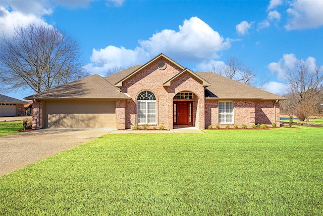 ranch-style house with a garage, concrete driveway, brick siding, and a front lawn