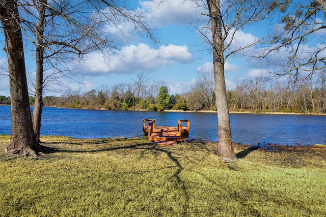 exterior space featuring a lawn and a water view