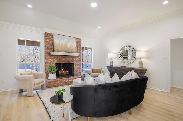 living room with ornamental molding, plenty of natural light, and light wood-style floors