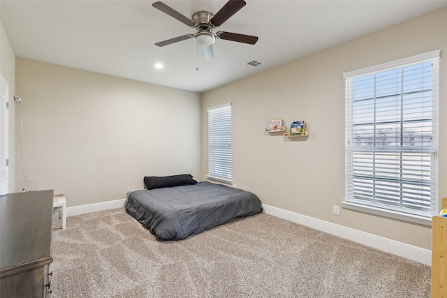 bedroom with a ceiling fan, carpet, visible vents, and baseboards