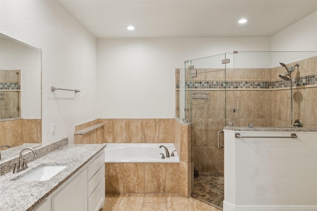 bathroom featuring a stall shower, a garden tub, vanity, and recessed lighting