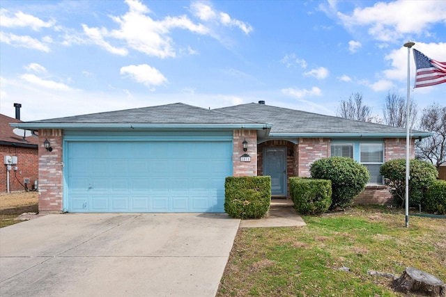 single story home featuring a garage, driveway, brick siding, and a front yard