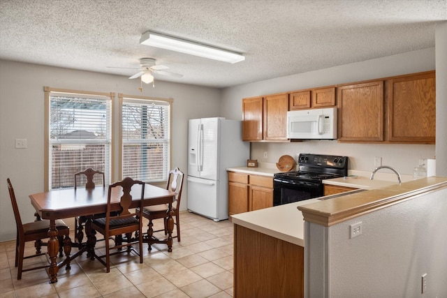 kitchen with light tile patterned floors, white appliances, a ceiling fan, light countertops, and brown cabinets