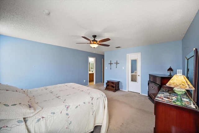 bedroom featuring light colored carpet, visible vents, ceiling fan, and a textured ceiling