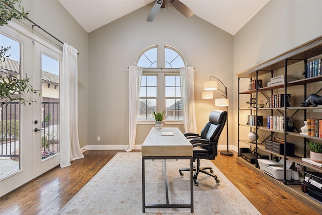 home office featuring lofted ceiling, baseboards, wood finished floors, and french doors