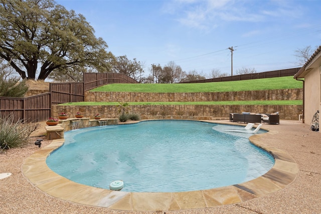 view of swimming pool featuring a fenced in pool, a patio area, a fenced backyard, and an outdoor hangout area