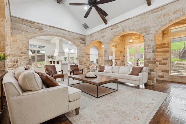 living area with visible vents, wood-type flooring, beamed ceiling, ornate columns, and high vaulted ceiling