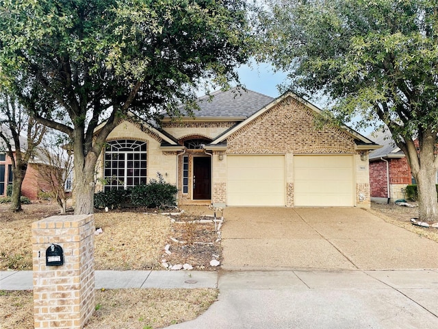 view of front of home featuring a garage, brick siding, driveway, and a shingled roof