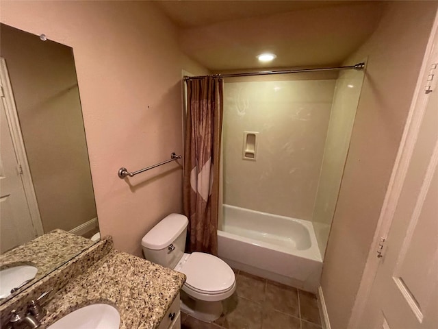 bathroom featuring toilet, shower / bath combo, vanity, tile patterned flooring, and baseboards