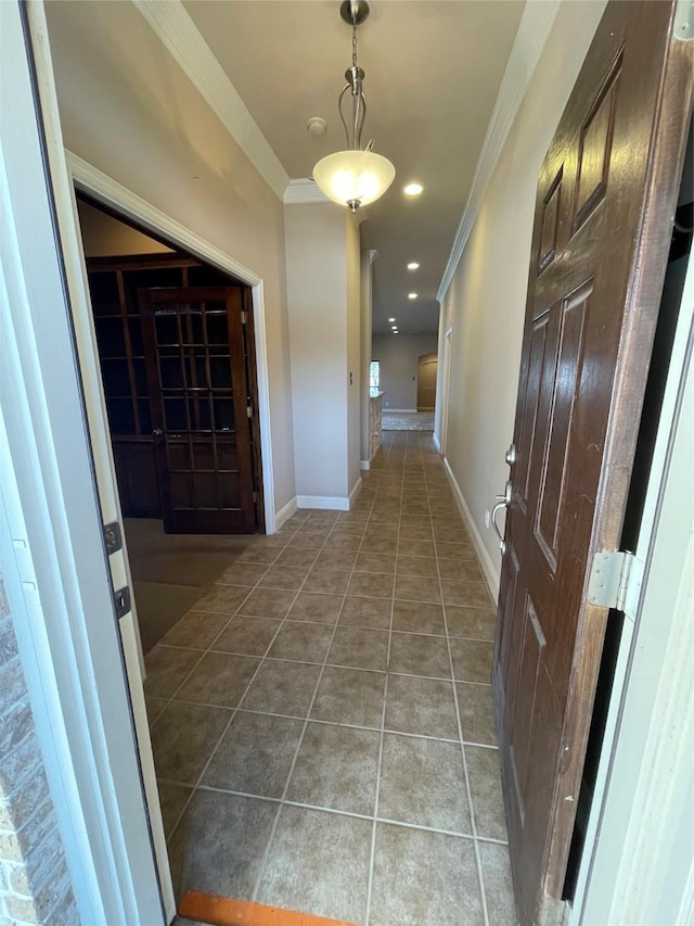 hallway featuring recessed lighting, baseboards, ornamental molding, and light tile patterned flooring