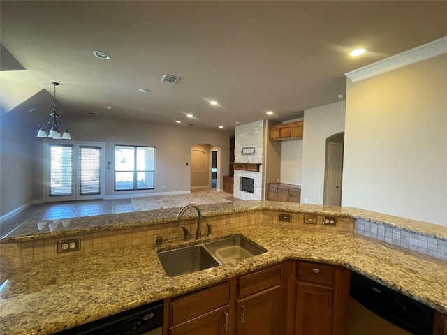 kitchen featuring arched walkways, a sink, visible vents, light stone countertops, and dishwasher