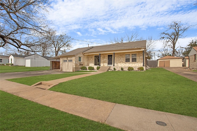 single story home featuring stone siding, a front yard, fence, and an outdoor structure