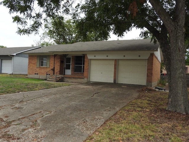 single story home with a garage, concrete driveway, brick siding, and crawl space