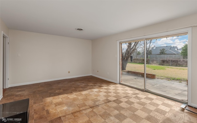 unfurnished room featuring visible vents and baseboards