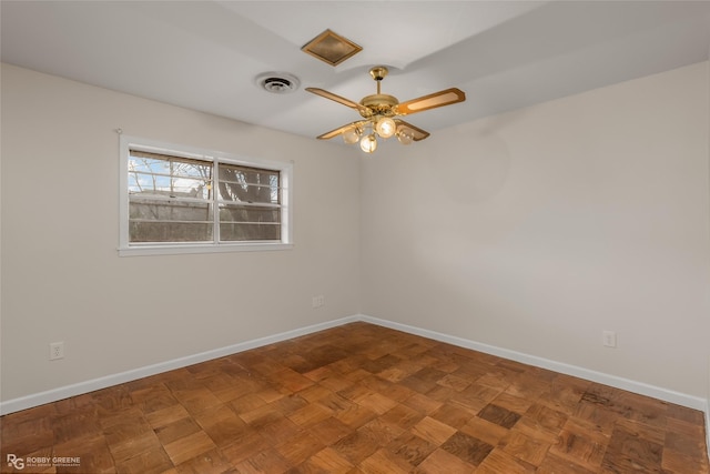 unfurnished room featuring ceiling fan, visible vents, and baseboards