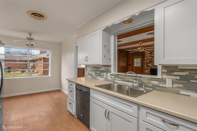 kitchen featuring a sink, visible vents, ornamental molding, dishwasher, and tasteful backsplash