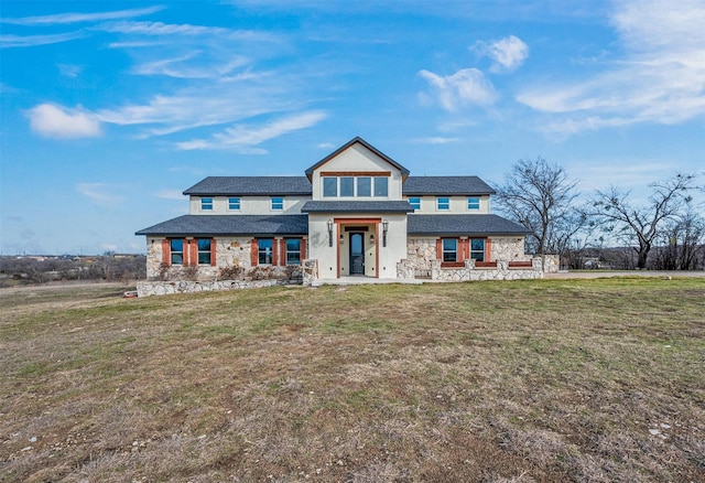 view of front facade featuring stone siding and a front lawn