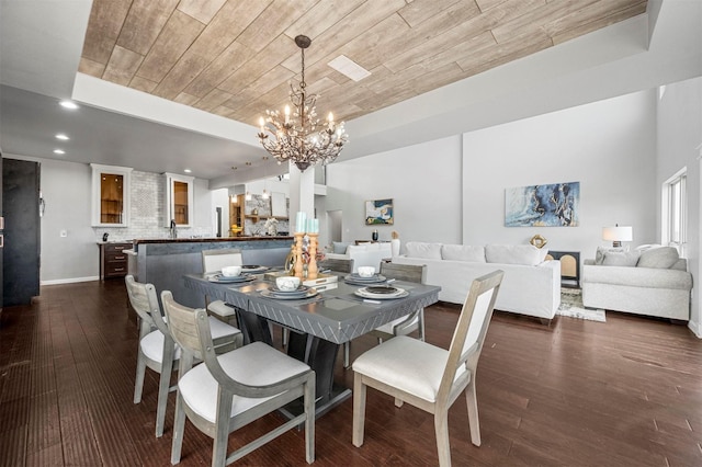 dining area featuring a chandelier, recessed lighting, wood ceiling, and dark wood finished floors