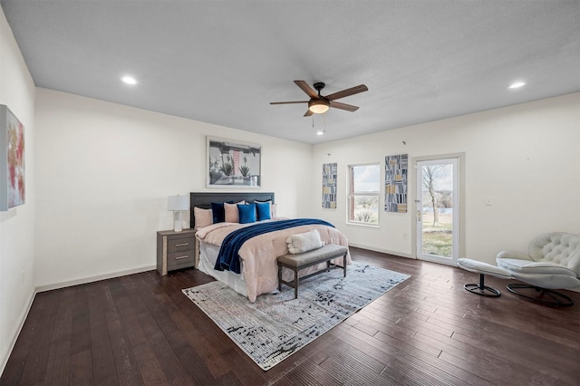 bedroom with access to outside, dark wood-style flooring, recessed lighting, and baseboards