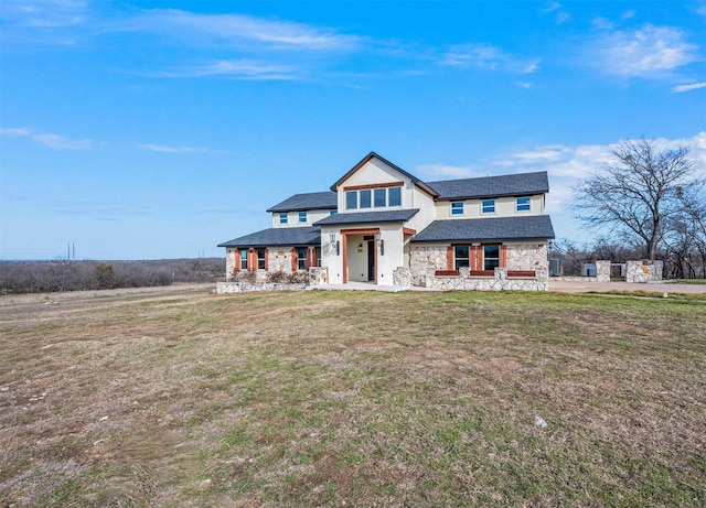 view of front of house with stone siding, stucco siding, and a front yard