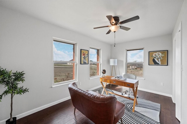 office featuring hardwood / wood-style floors, a ceiling fan, and baseboards