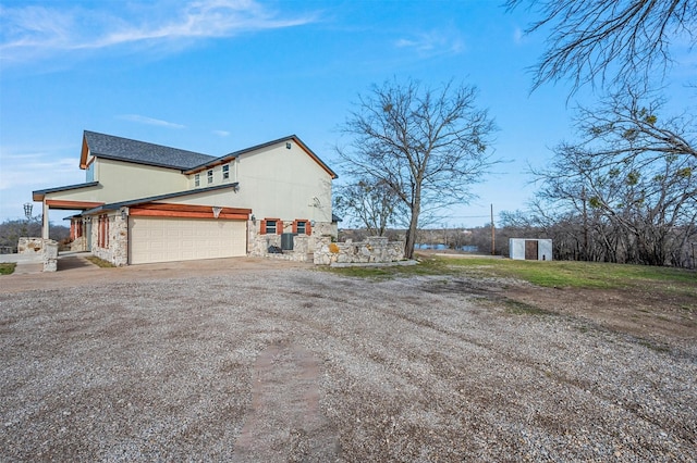 view of home's exterior with stone siding, driveway, and stucco siding