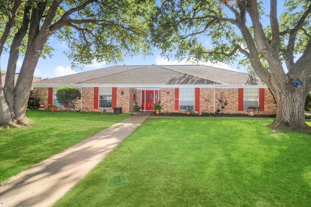 ranch-style house with a front lawn and brick siding