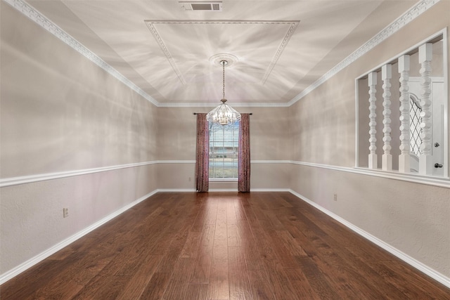 spare room with hardwood / wood-style flooring, baseboards, ornamental molding, and a notable chandelier