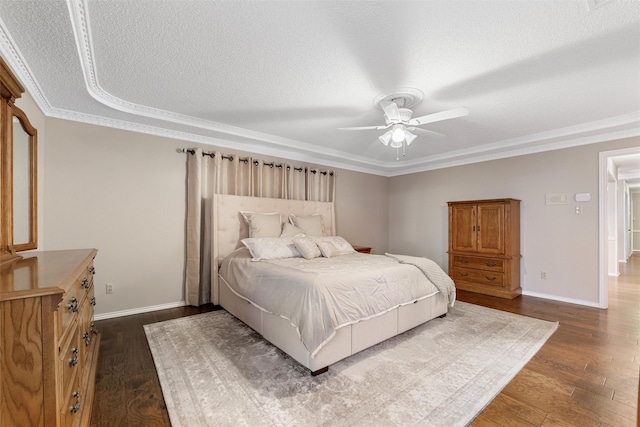 bedroom featuring a textured ceiling, dark wood finished floors, and baseboards