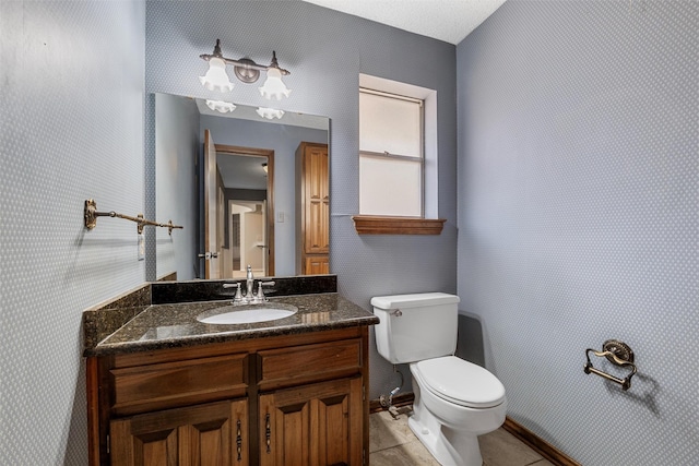 bathroom featuring toilet, tile patterned flooring, and vanity