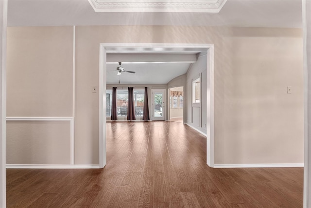 interior space featuring a ceiling fan, vaulted ceiling with skylight, baseboards, and wood finished floors