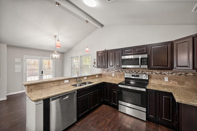 kitchen featuring dark wood-style flooring, vaulted ceiling with beams, stainless steel appliances, a sink, and a peninsula