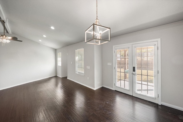 spare room featuring a wealth of natural light, baseboards, dark wood-style flooring, and french doors