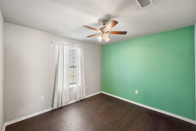 unfurnished room with a ceiling fan, baseboards, visible vents, and dark wood-style flooring