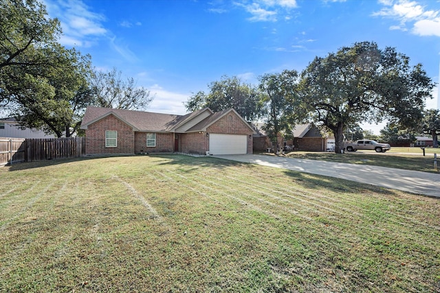 single story home with a garage, concrete driveway, fence, a front lawn, and brick siding