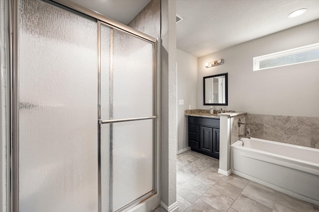 full bathroom with a stall shower, a garden tub, vanity, and baseboards