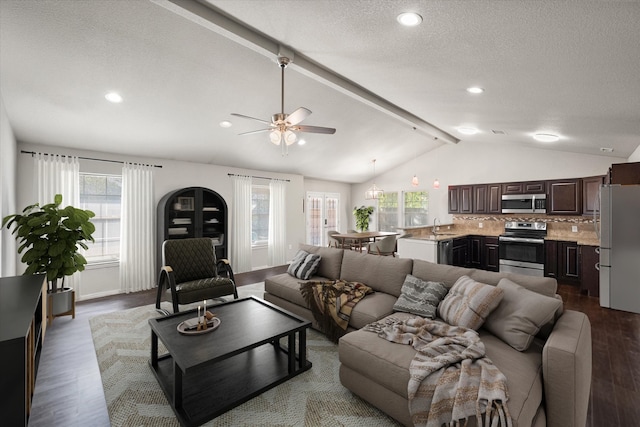 living area with dark wood-style flooring, recessed lighting, lofted ceiling with beams, a ceiling fan, and a textured ceiling