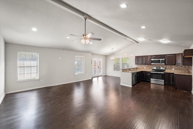 kitchen featuring lofted ceiling with beams, stainless steel appliances, dark wood-style flooring, open floor plan, and light countertops